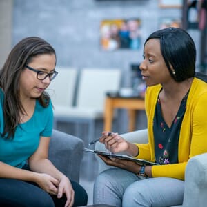 Therapist talking with concerned woman client