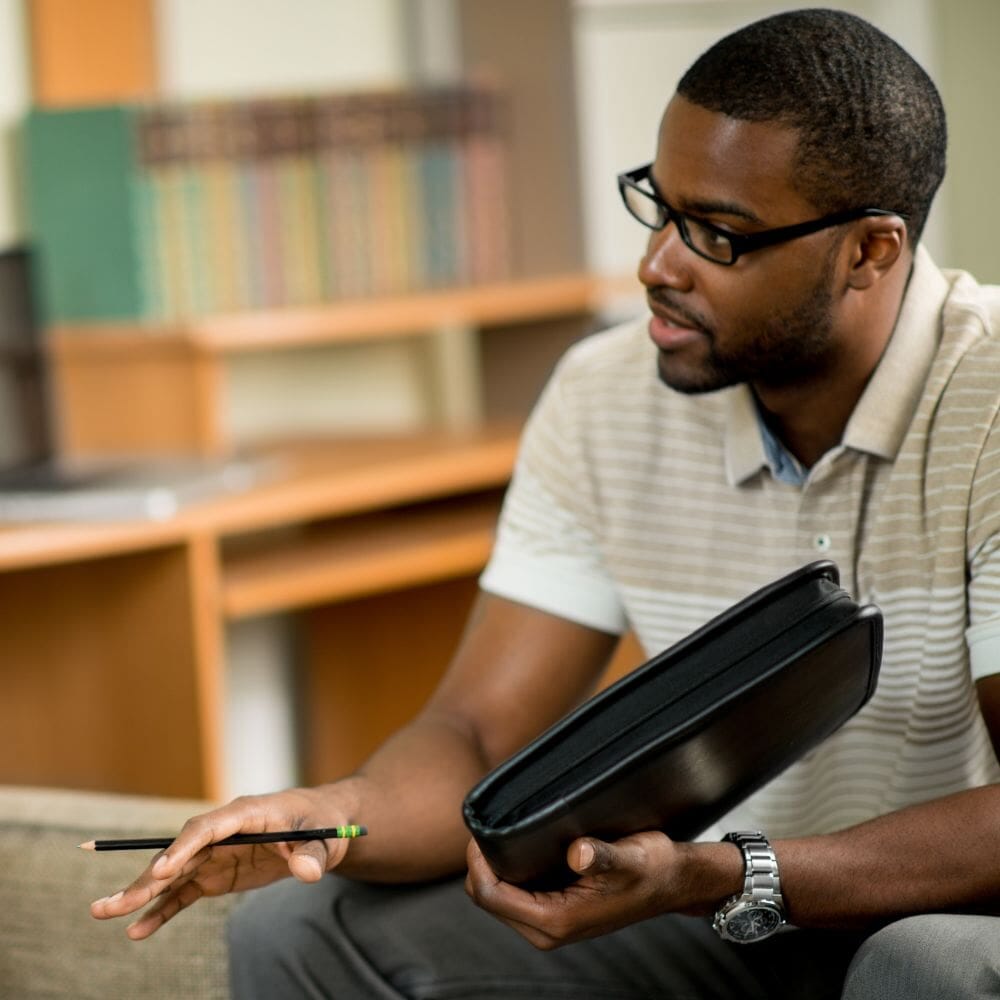 Therapist holding notebook and pencil. while talking