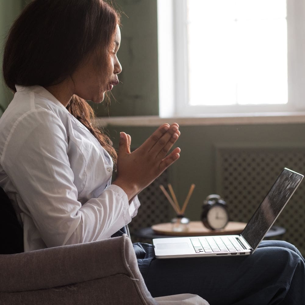  A female therapist in a white coat conducts an online therapy session 