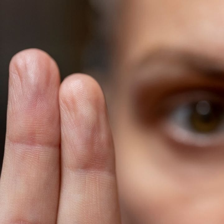 Close-up of two raised fingers used to guide bilateral eye movements.
