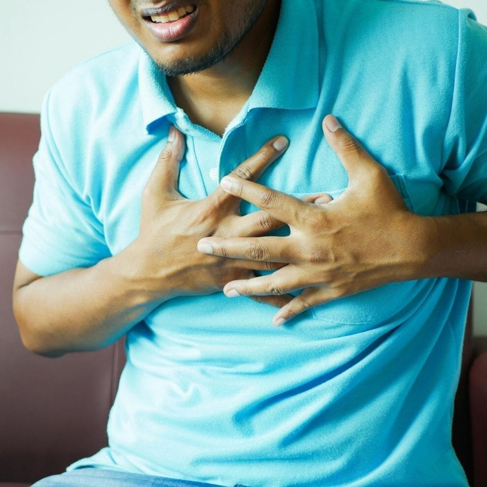 Man clutching chest during a panic or anxiety attack.